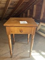 View of the antique maple side table showing single drawer and turned legs