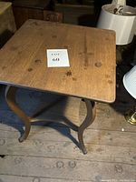 Top view of the oak parlor table showing the square top surface with stains and wood marks.