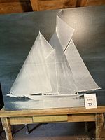 Full view of sailboat artwork showing sailboat with multiple sails on calm water.