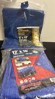 Two new polyethylene tarps in original packaging, one 12x16 and one 8x10 utility tarp.