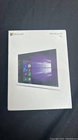 Front view of sealed Microsoft Windows 10 Pro retail box showing product branding and user interface image.
