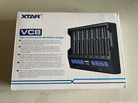 Front of the retail box showing XTAR brand, VC8 model, product image of the 8-slot battery charger with LCD screen and Type-C input.