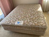 Queen size floral patterned Simmons Beautyrest Elite mattress on top of matching boxspring, showing fabric and overall condition.