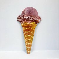 Photo of a single chocolate ice cream cone lithograph shaped artwork on a white background.