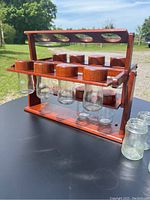 Overall view of the teak carousel spice rack with glass spice jars mounted, showing the design and structure