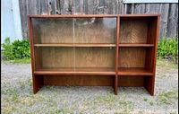 Front view of vintage walnut hutch bookcase showing glass sliding door on left and open shelves on right