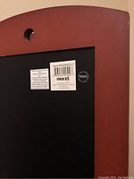 Close-up of the back of the picture frame with the brand sticker 'nexxt' and item number PNO9520-7.