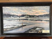 Framed oil painting showing winter landscape with dock and frozen water titled 'January Thaw' by Bruce Sherman.