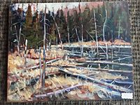 Full view of oil painting showing fallen spruce logs and standing trees against dense forest background