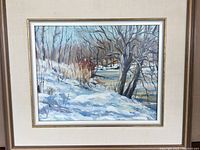 Front view of framed oil painting depicting snow-covered riverbank with trees, signed by Bruce Sherman.