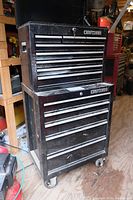 Full view of stacked top and bottom Craftsman black steel tool chest on casters