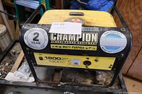 Front view of the Champion generator showing brand, starting watts (1800), rated watts (1400) and other labels.