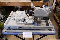 Front view of the Kobalt wet tile saw on a folding stand.