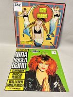 Front covers of the two Nina Hagen vinyl record albums, one titled Fearless with images of Nina Hagen and the other with Nina Hagen Band showing Nina Hagen with red hair and praying hands pose.