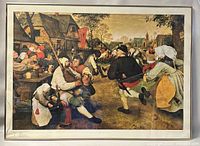 Full view of framed print showing village scene with people and visible cracked glass on the lower left corner of the glass panel.