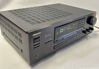 Front angled view of the Onkyo TX-8511 receiver showing its vented black metal top, headphone jack, digital display, and buttons.