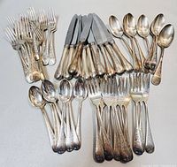 Full set layout showing grouped forks, knives, and spoons on light grey background