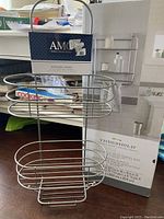 Threshold wall shelf with towel bar box in background and AMCO shower caddy in front, highlighting both lot items