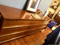 Front view of the 9 drawer dresser showing the wood finish and drawer arrangement.