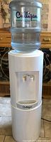 Front view of Culligan water cooler with clear Culligan water bottle installed
