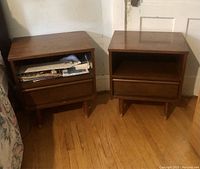Photo of two wooden bedside tables next to each other, showing front and side view with drawer and shelf.