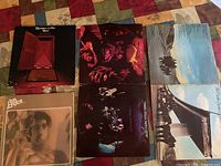 Overview of four vintage rock albums laid together showing front covers, including double album gatefold cover.