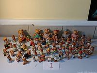 Wide view of all porcelain bear figurines arranged on table