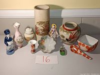 Full view of all 10 vintage Japanese glass and porcelain decorative items arranged together, showing overall condition and design.