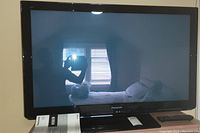 Front view of Panasonic 42-inch plasma TV model TC-P42X3 on stand showing screen and frame.