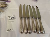 Set of six silver handle cutters arranged side by side showing overall shape and size.