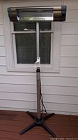 Front view of standing electric heater showing rectangular heating element and grille