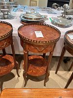 Full front view of round wooden side table showing overall design