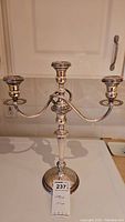 Full front view of three-arm candelabra on white counter