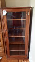 Full front view showing cabinet door, interior shelves, and overall height