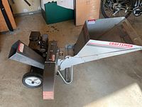 Side view of the Craftsman chipper shredder showing hopper, wheels, and gas engine.