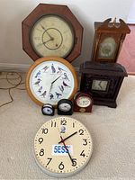Group photo of all clocks showing variety in shapes, sizes, and styles.