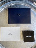 Pearl box collection including black Richelieu box and white M B. Geocs box