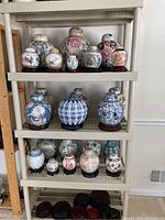 Full view of plastic shelving unit filled with various ceramic jars and wooden bases (contents not included)