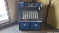 Front view of the AMI jukebox showing selection panel and lower blue doors.