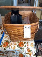 Photo showing the woven wooden basket used to hold the sewing notions