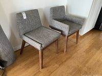 Two chairs side by side against wall, front view