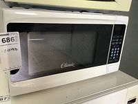 Front view of the white Classic brand microwave oven with glass door and control panel.