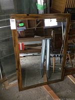 Front view of the rectangular wood framed mirror showing the full reflective surface and frame detail.