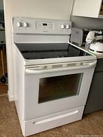 Full front view of white Frigidaire range showing cooktop, control panel, oven door and storage drawer.