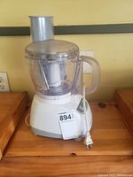Photo of the Black & Decker food processor showing white base, clear bowl with lid, and power cord.
