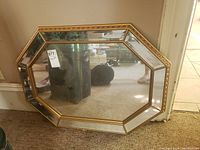 Full view of octagonal mirror with gold trimmed frame