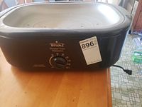 Front view of the Rival Roaster Oven showing the temperature control knob and brand label.