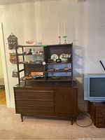 Full view of walnut buffet and hutch assembled against wall, showing overall shape and finish