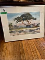 Framed original watercolour artwork showing a landscape with a large tree, rocks, and background hills
