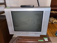 Front view of the Sony 36 inch CRT television with remote control on top, showing the screen and front panel buttons.